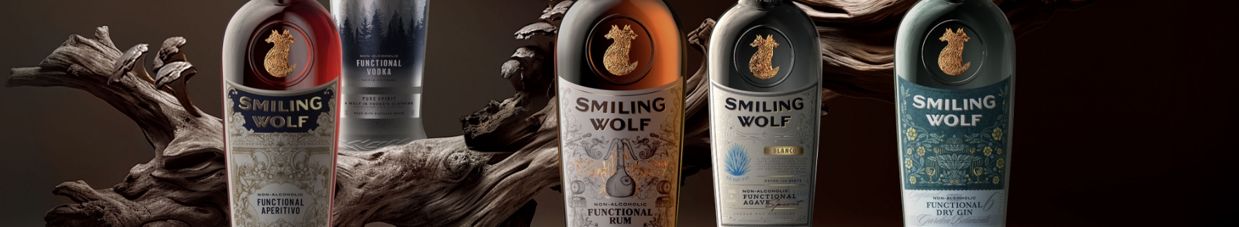 Five Smiling Wolf non-alcoholic spirits, Aperitivo, Vodka, Rum, Agave, and Gin, displayed against dark wood