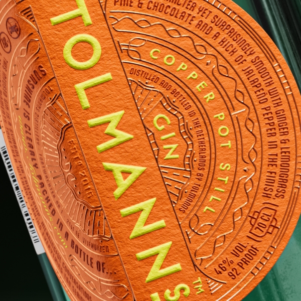 Close-up of the Smiling Wolf Functional Rum label, showing detailed gold and black illustrations of stills, barrels, and cannons.